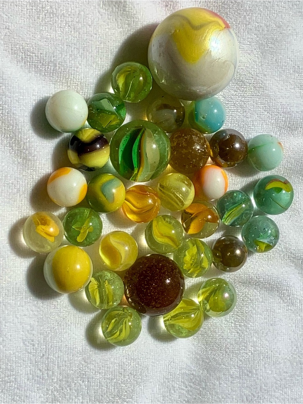 Vintage Yellow colored 32 piece collection of glass marbles